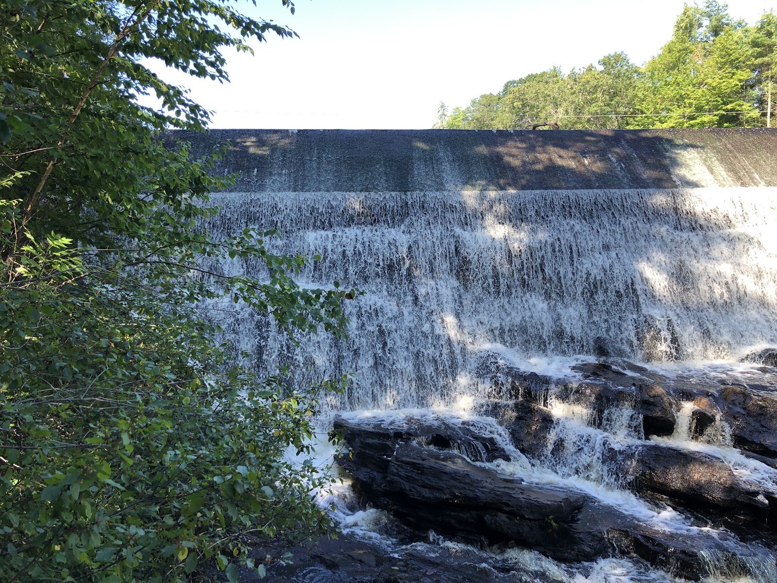 Water over the dam face in the years before restoration began.