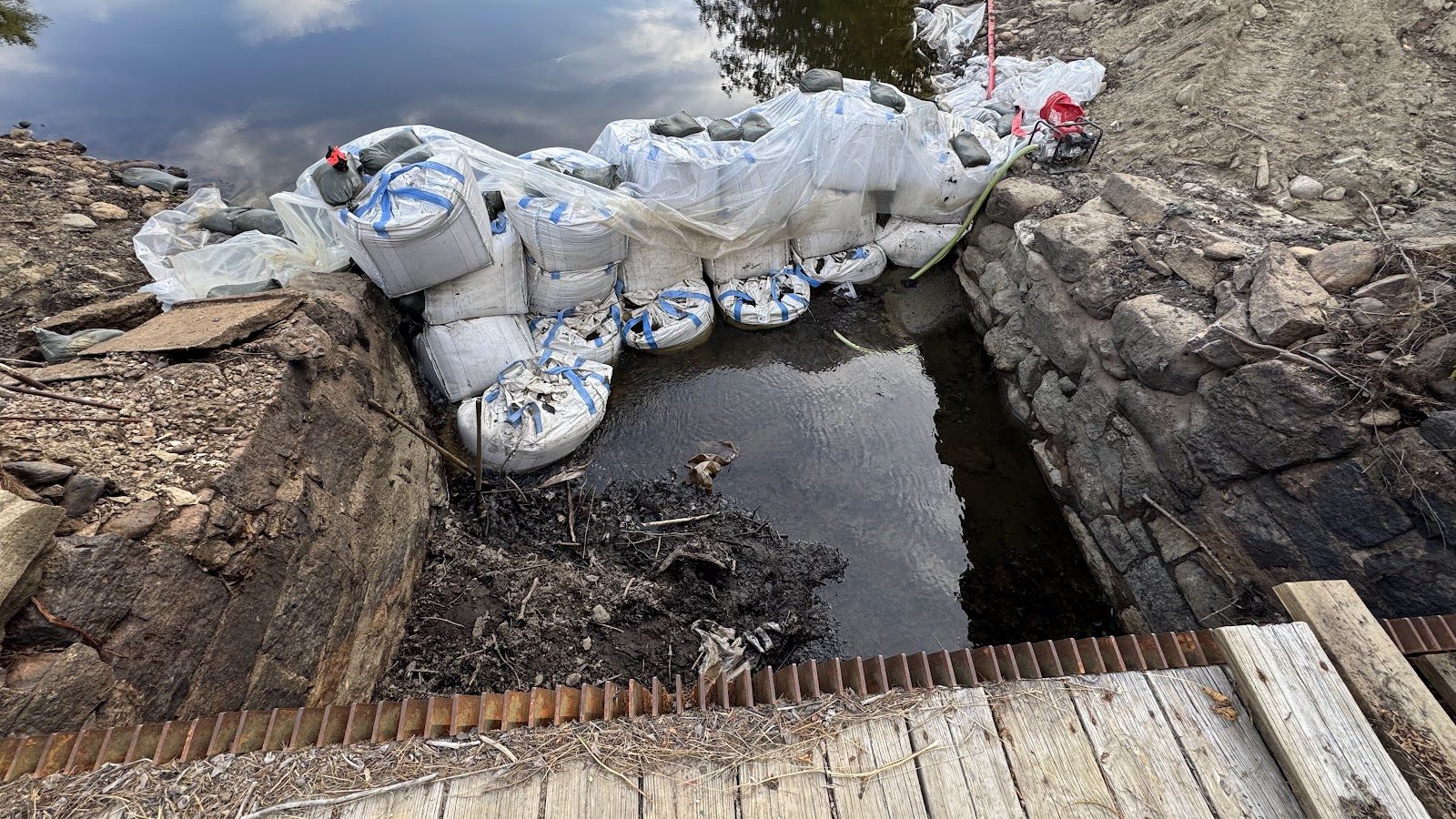One-ton sandbags holding back the pond.