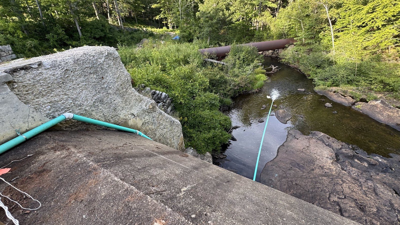 The siphon line over the dam, keeping the river fed.