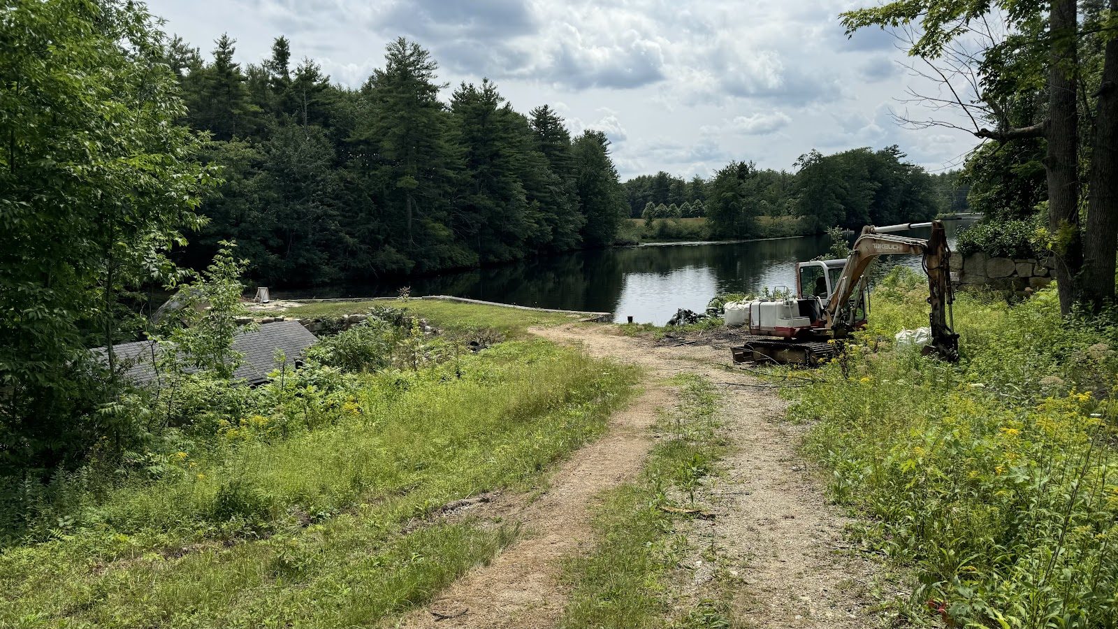 The drawdown underway — equipment on the exposed bank.