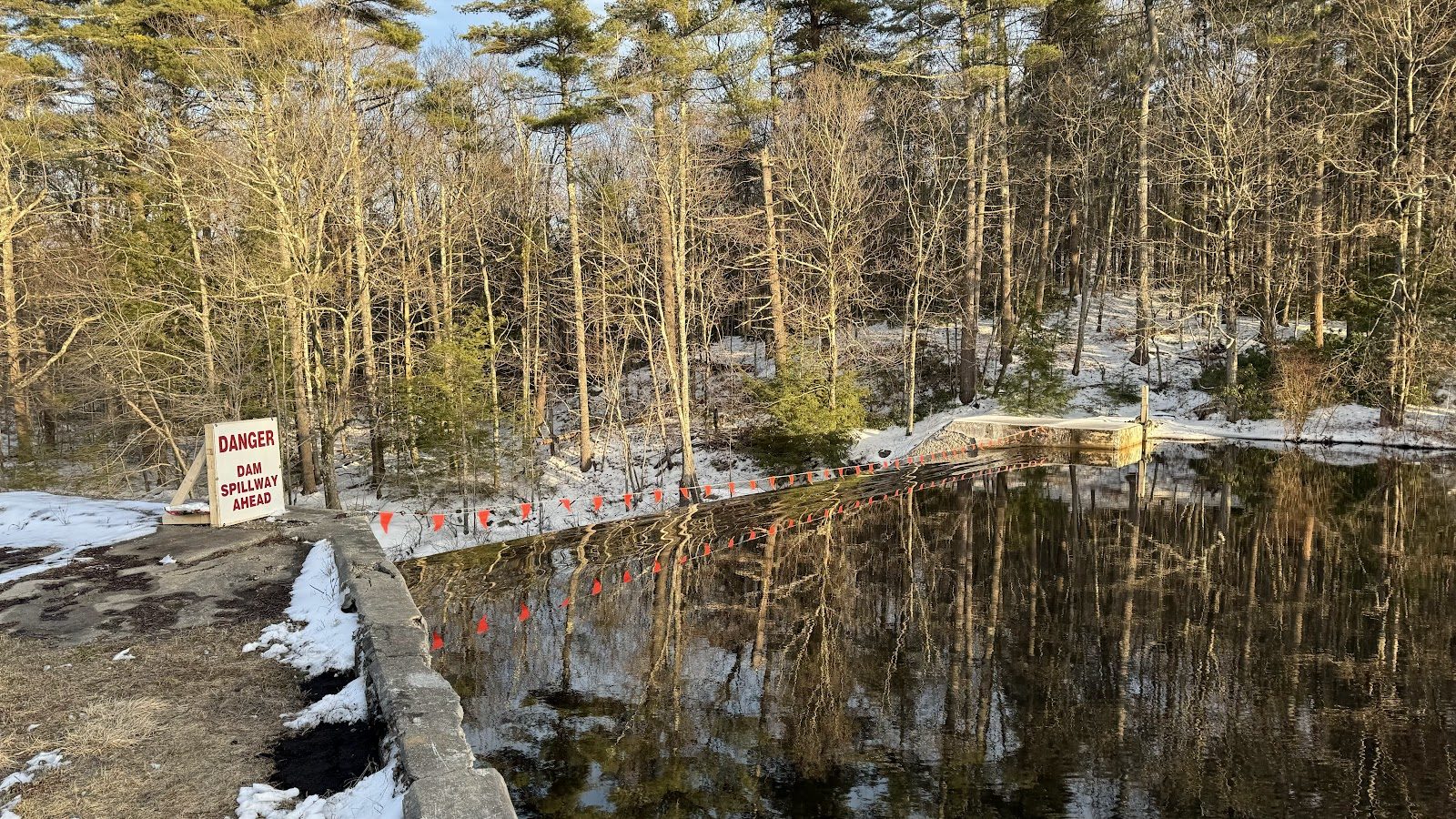 Late-winter pond, posted and quiet.
