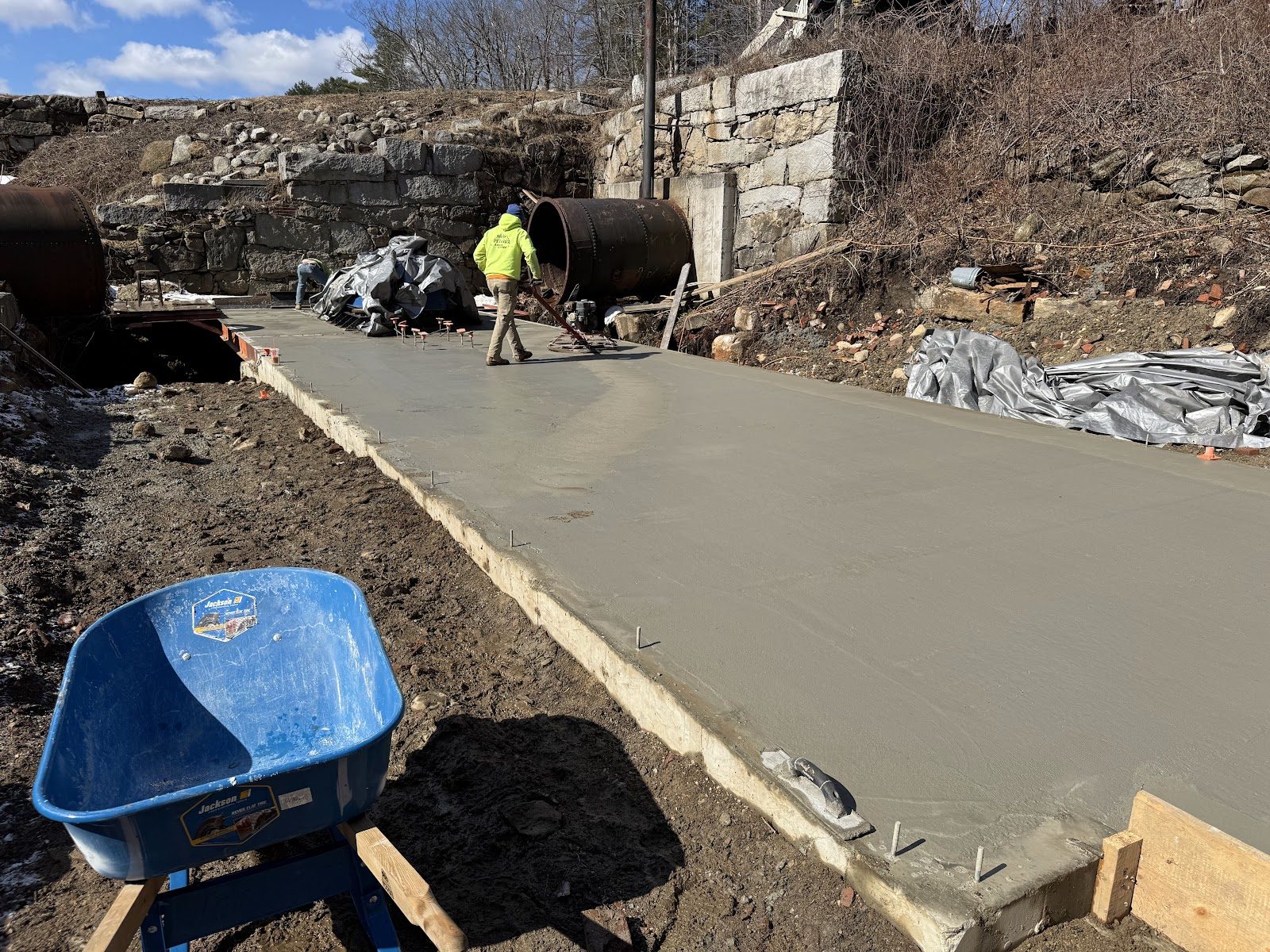 Screeding a fresh pour beside the penstock.