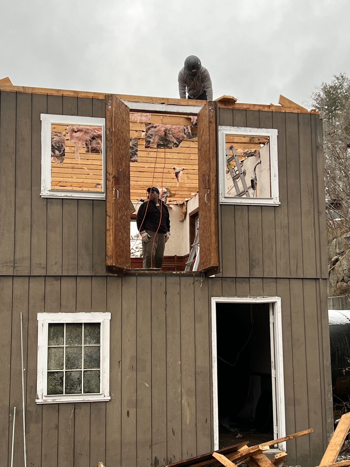 Wall sheathing coming off, piece by piece.